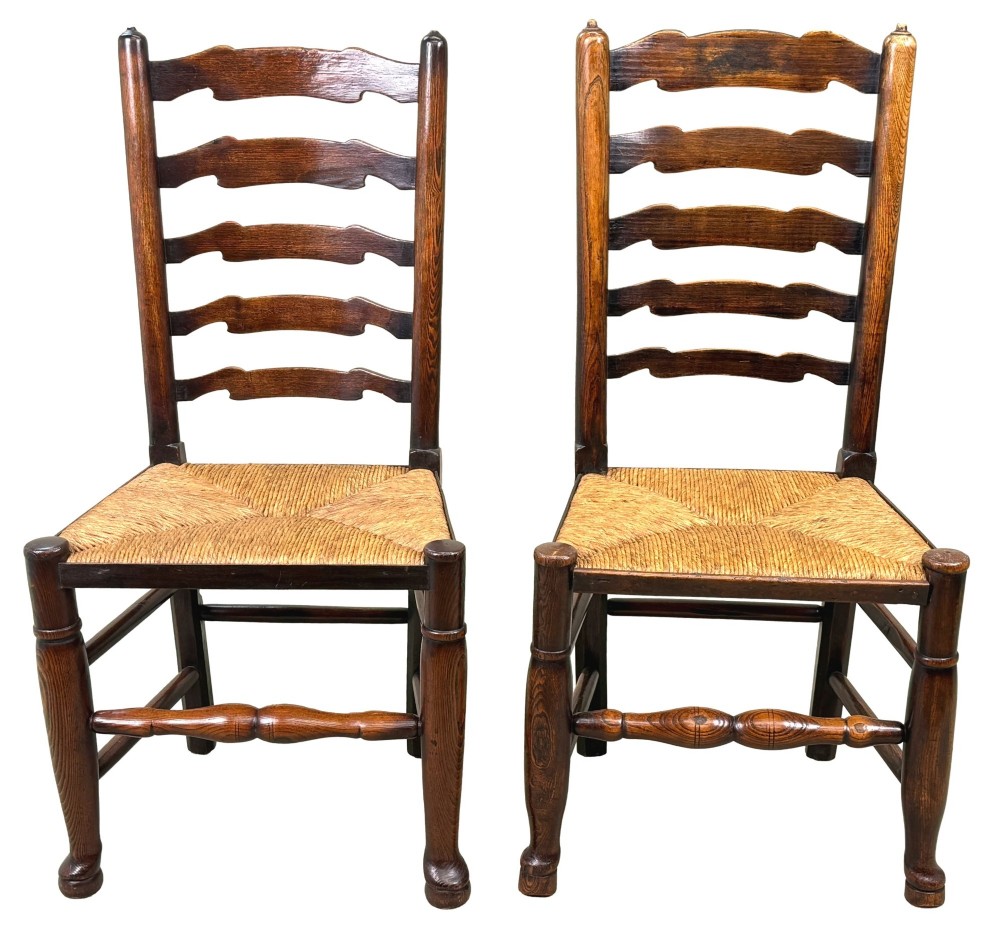 A set of ten early 19th-century Georgian country dining chairs featuring waved ladderback slats, woven rush seats, and turned wooden legs. View II