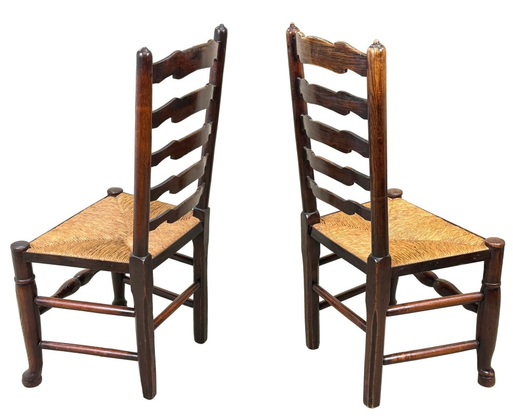 A set of ten early 19th-century Georgian country dining chairs featuring waved ladderback slats, woven rush seats, and turned wooden legs. View III