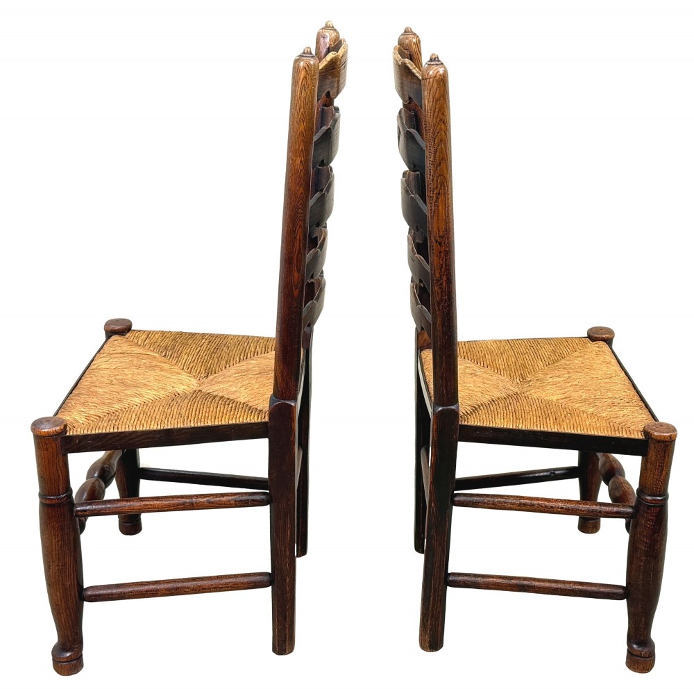 A set of ten early 19th-century Georgian country dining chairs featuring waved ladderback slats, woven rush seats, and turned wooden legs. View VIII