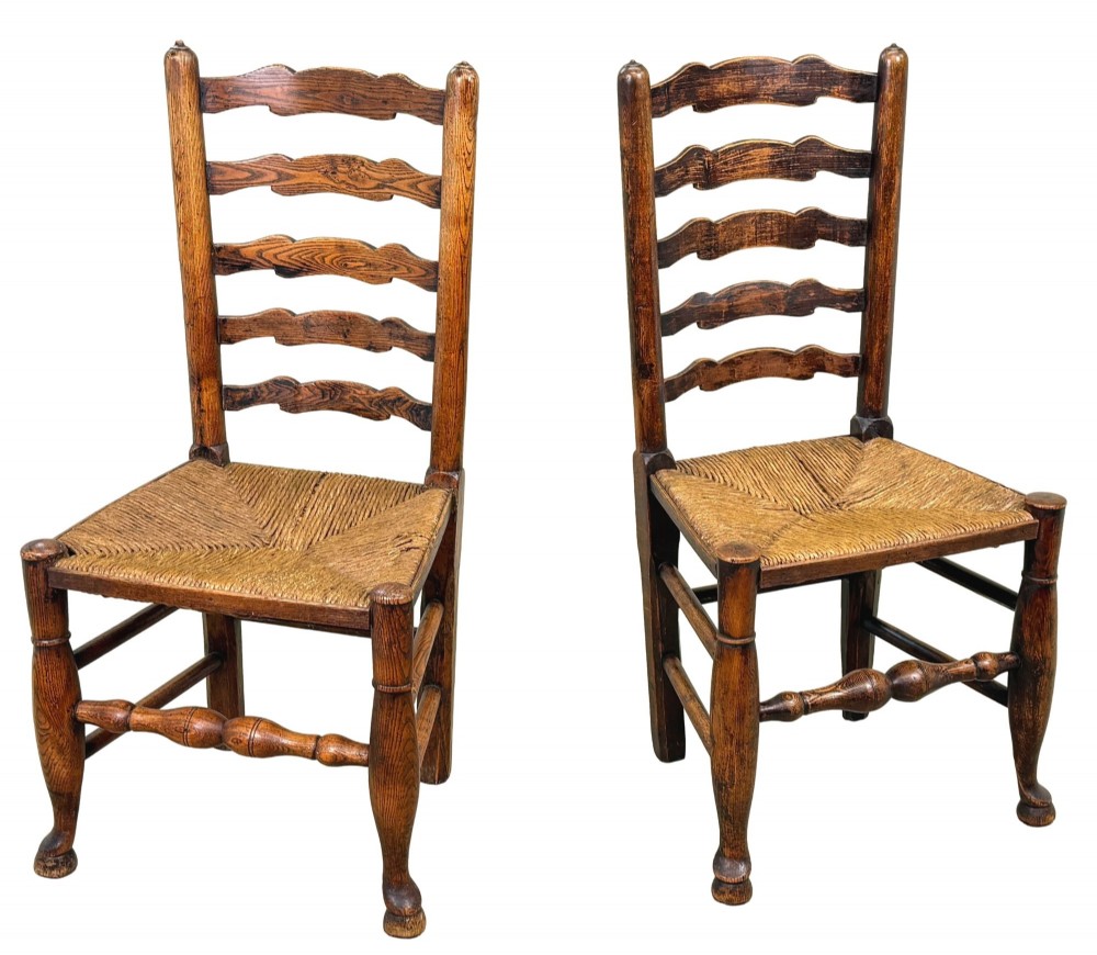 A set of ten early 19th-century Georgian country dining chairs featuring waved ladderback slats, woven rush seats, and turned wooden legs. View XI