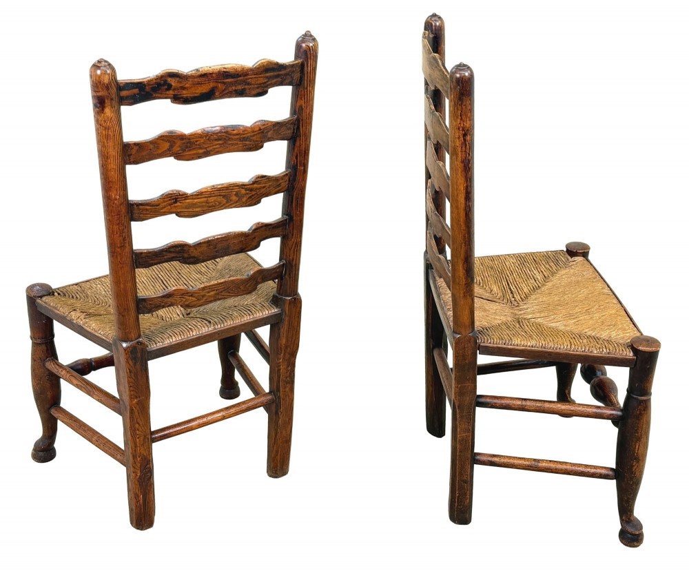 A set of ten early 19th-century Georgian country dining chairs featuring waved ladderback slats, woven rush seats, and turned wooden legs. View XII