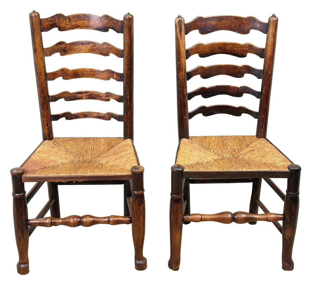 A set of ten early 19th-century Georgian country dining chairs featuring waved ladderback slats, woven rush seats, and turned wooden legs. View XIV