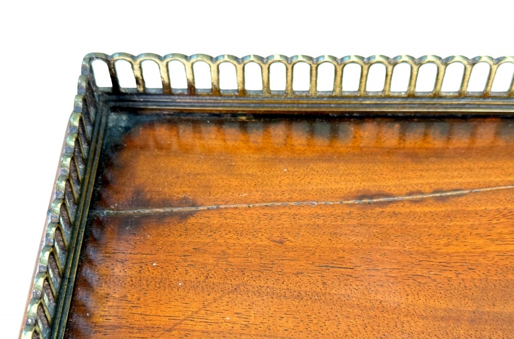 A three-tier Regency mahogany whatnot featuring a pierced brass gallery top rail, turned support columns, and brass castors. View XI