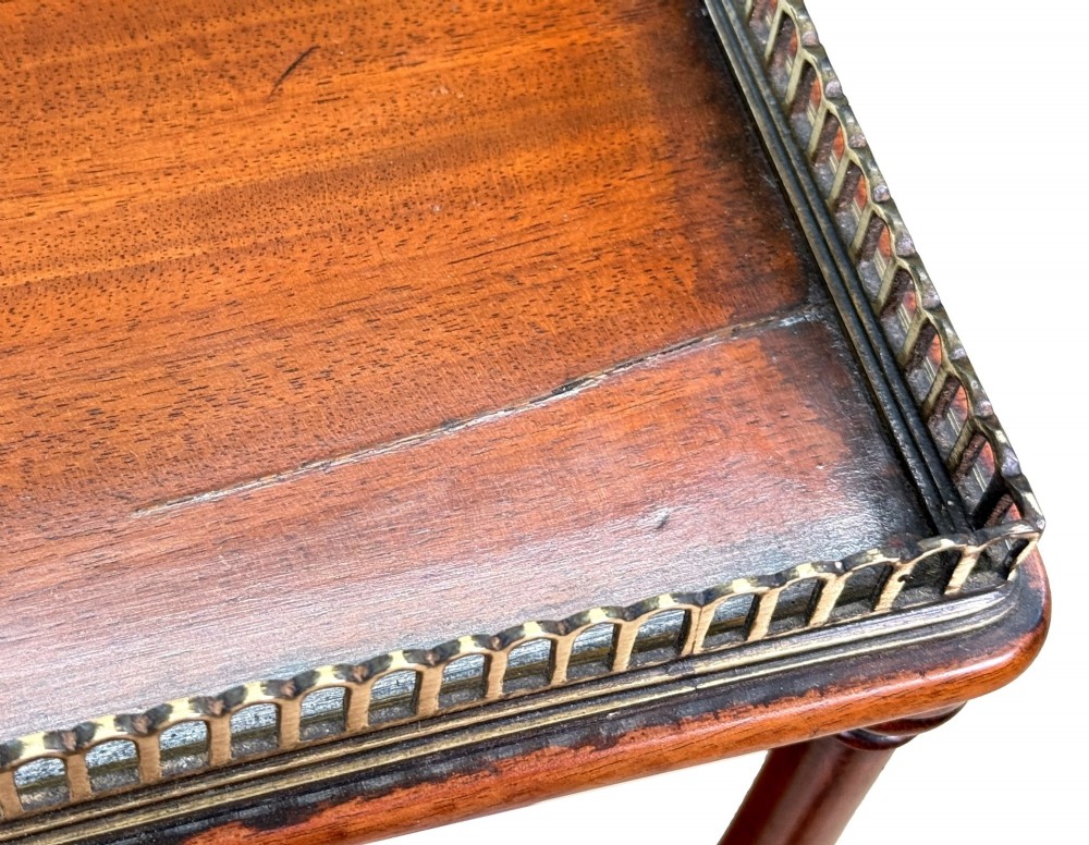 A three-tier Regency mahogany whatnot featuring a pierced brass gallery top rail, turned support columns, and brass castors. View XIII