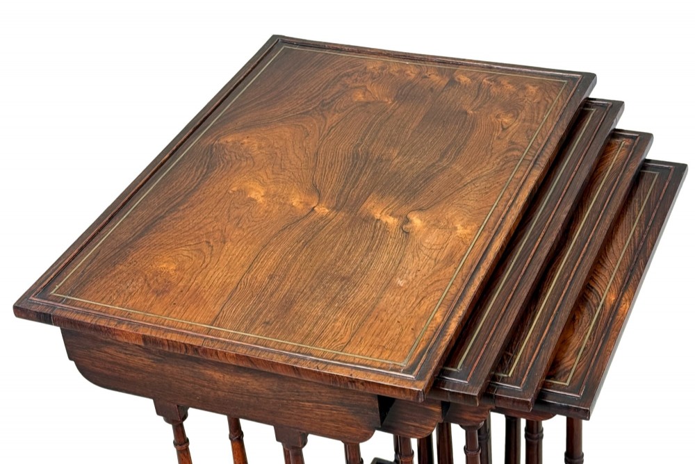 A set of four Regency period rosewood quartetto nesting tables with slender faux-bamboo turned legs and trestle feet. View IV