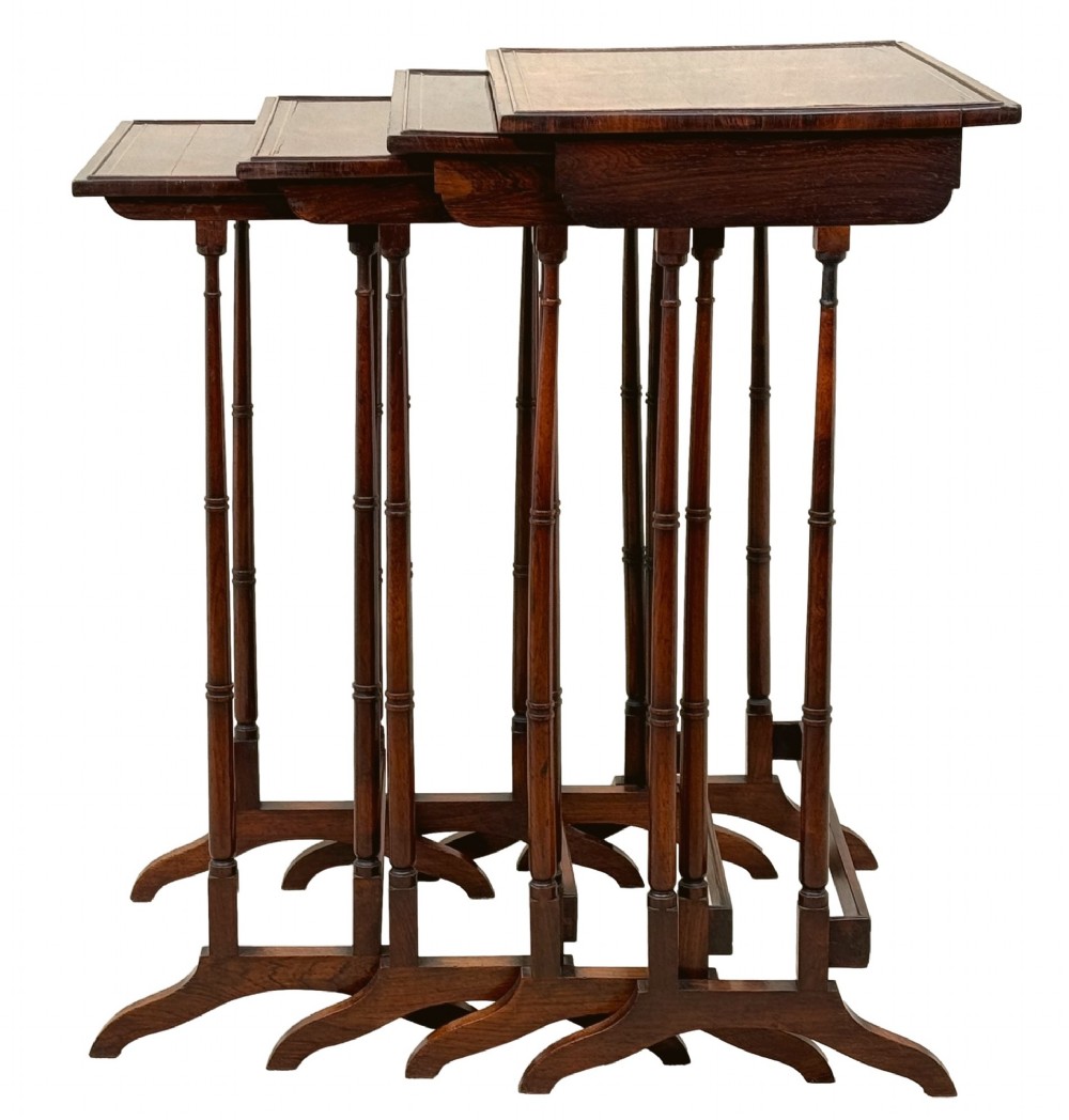 A set of four Regency period rosewood quartetto nesting tables with slender faux-bamboo turned legs and trestle feet. View V