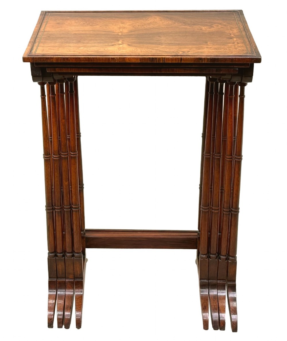 A set of four Regency period rosewood quartetto nesting tables with slender faux-bamboo turned legs and trestle feet. View VIII
