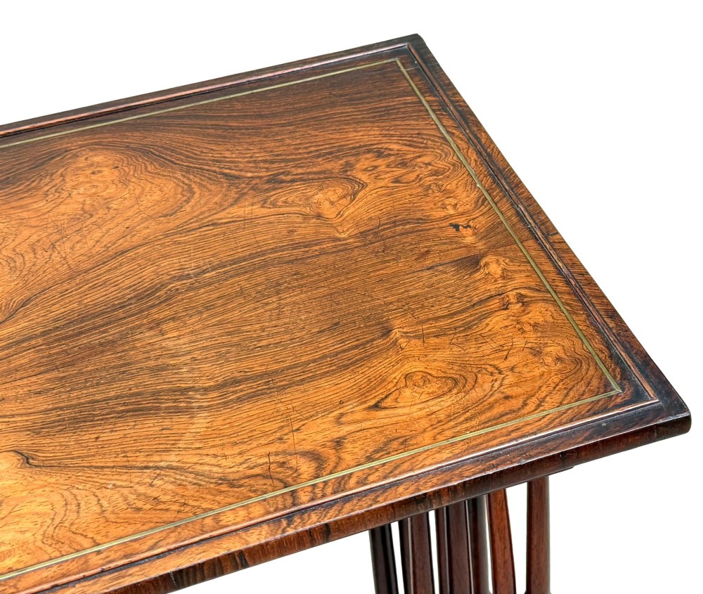 A set of four Regency period rosewood quartetto nesting tables with slender faux-bamboo turned legs and trestle feet. View IX