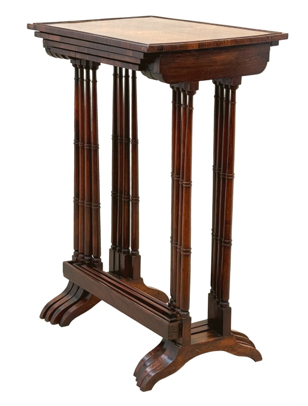 A set of four Regency period rosewood quartetto nesting tables with slender faux-bamboo turned legs and trestle feet. View X
