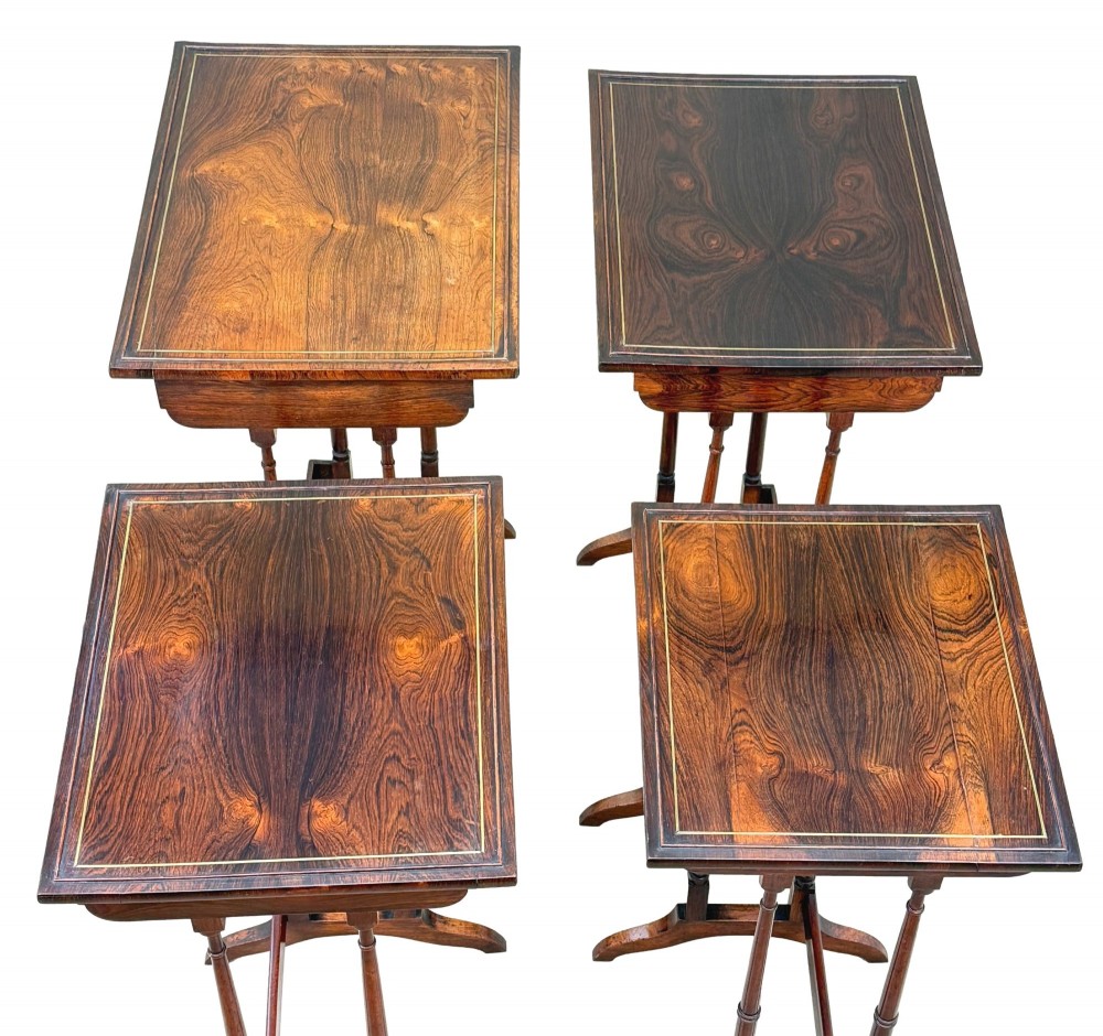 A set of four Regency period rosewood quartetto nesting tables with slender faux-bamboo turned legs and trestle feet. View XIII