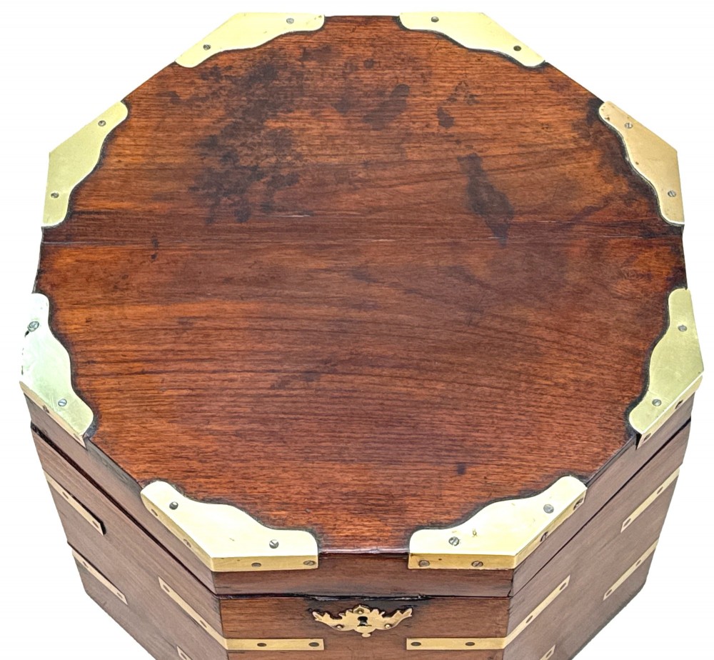 An octagonal eighteenth-century Anglo-Indian padouk wood cellarette with brass corner straps, keyhole escutcheon, and carrying handles, supported on four cabriole legs. View II