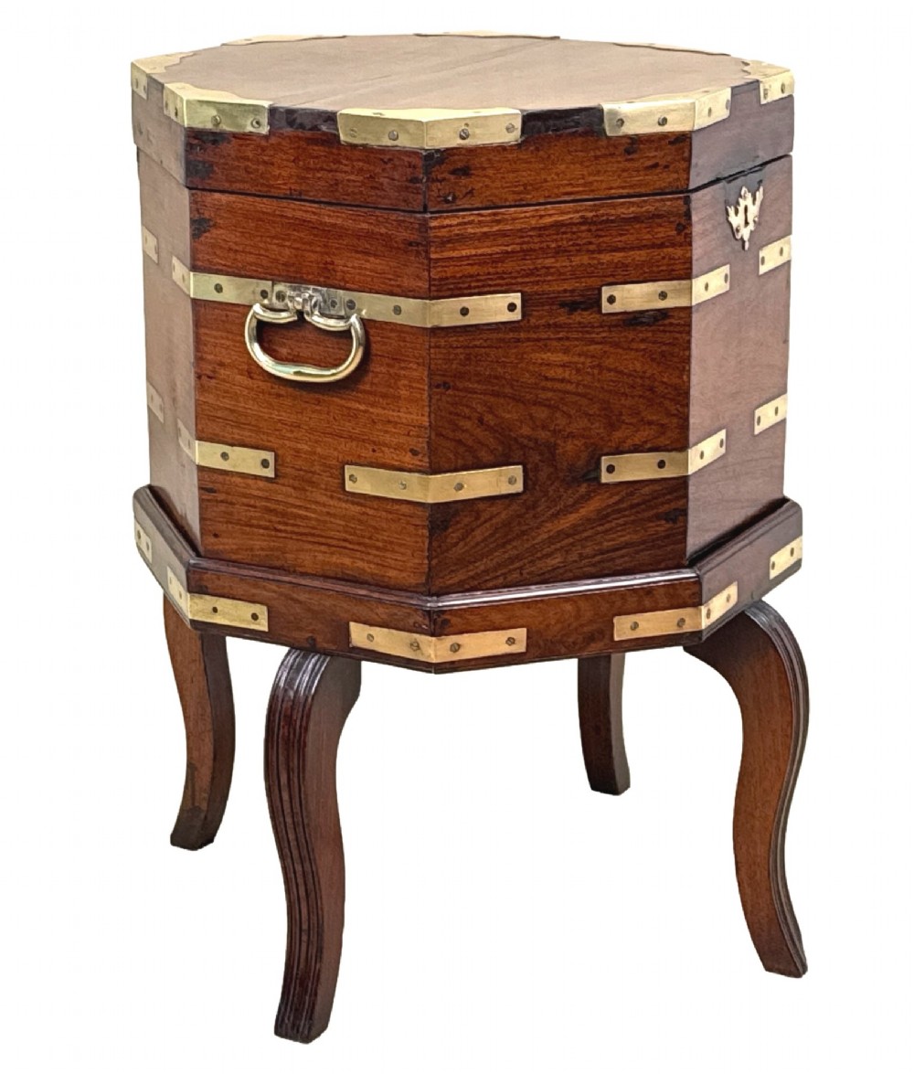 An octagonal eighteenth-century Anglo-Indian padouk wood cellarette with brass corner straps, keyhole escutcheon, and carrying handles, supported on four cabriole legs. View XII