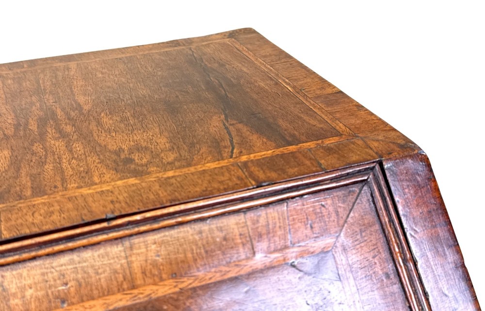 An early 18th-century walnut bureau on legs featuring a slant-front lid, small drawers with brass teardrop handles, and cabriole legs. View XIII