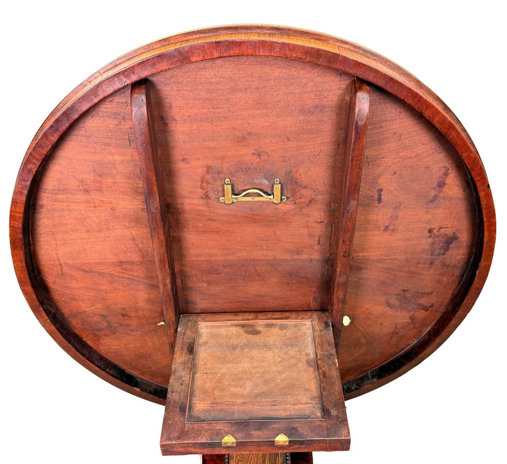 A circular Regency rosewood centre table featuring brass inlay motifs around the rim, a central pedestal support, and a quadform base with splayed legs ending in brass paw castors. View VI