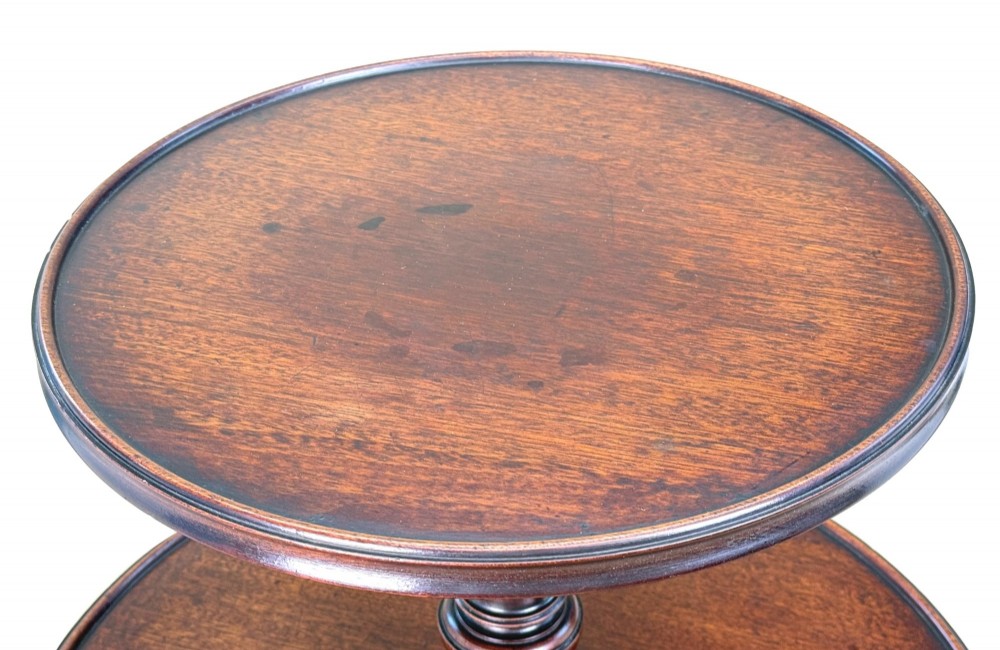An 18th-century Georgian mahogany dumbwaiter featuring three graduated circular dished tiers supported by a turned central column and a tripod base with pad feet. View II