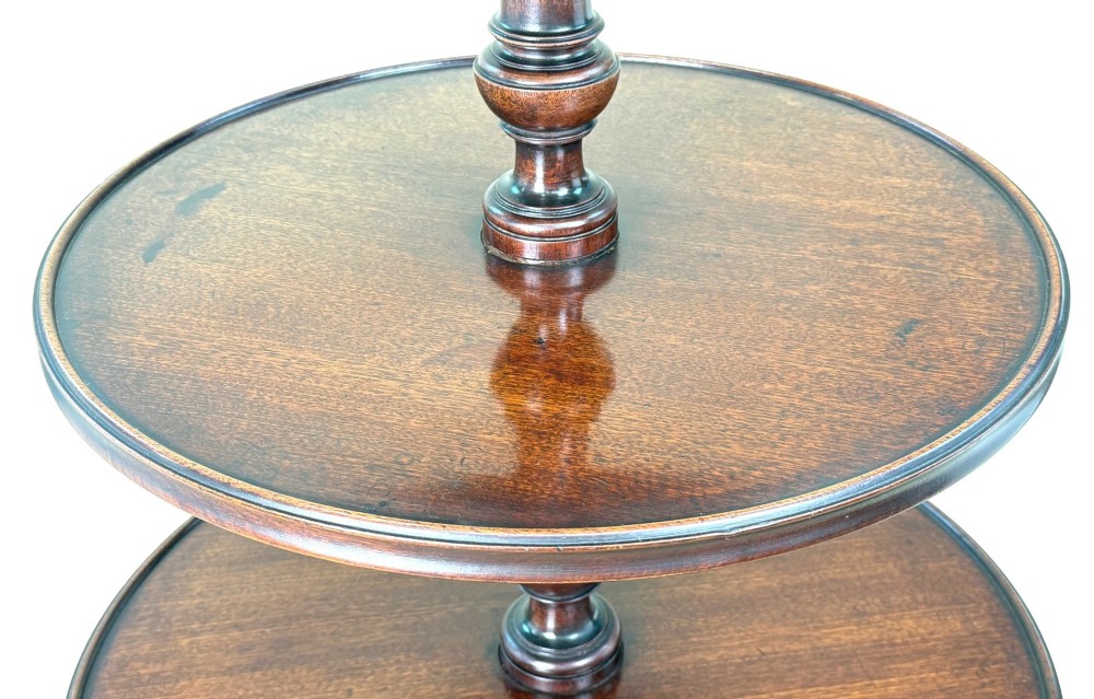 An 18th-century Georgian mahogany dumbwaiter featuring three graduated circular dished tiers supported by a turned central column and a tripod base with pad feet. View V