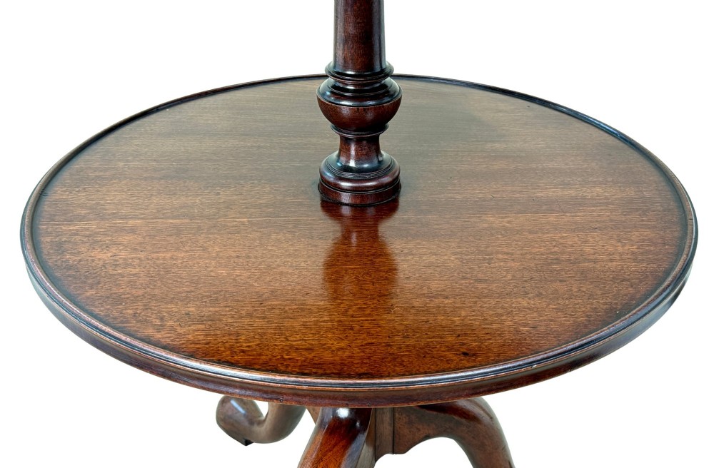 An 18th-century Georgian mahogany dumbwaiter featuring three graduated circular dished tiers supported by a turned central column and a tripod base with pad feet. View VII