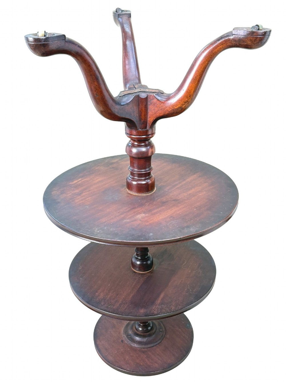 An 18th-century Georgian mahogany dumbwaiter featuring three graduated circular dished tiers supported by a turned central column and a tripod base with pad feet. View XI