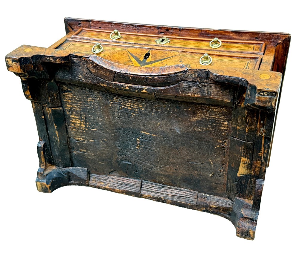 An early 18th-century walnut miniature chest featuring two drawers, star marquetry inlay, crossbanding, brass drop ring handles, and bracket feet. View XII
