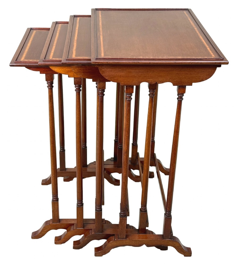 A 19th-century set of four graduated mahogany nesting tables featuring slender turned spindle legs and sledge feet. View II
