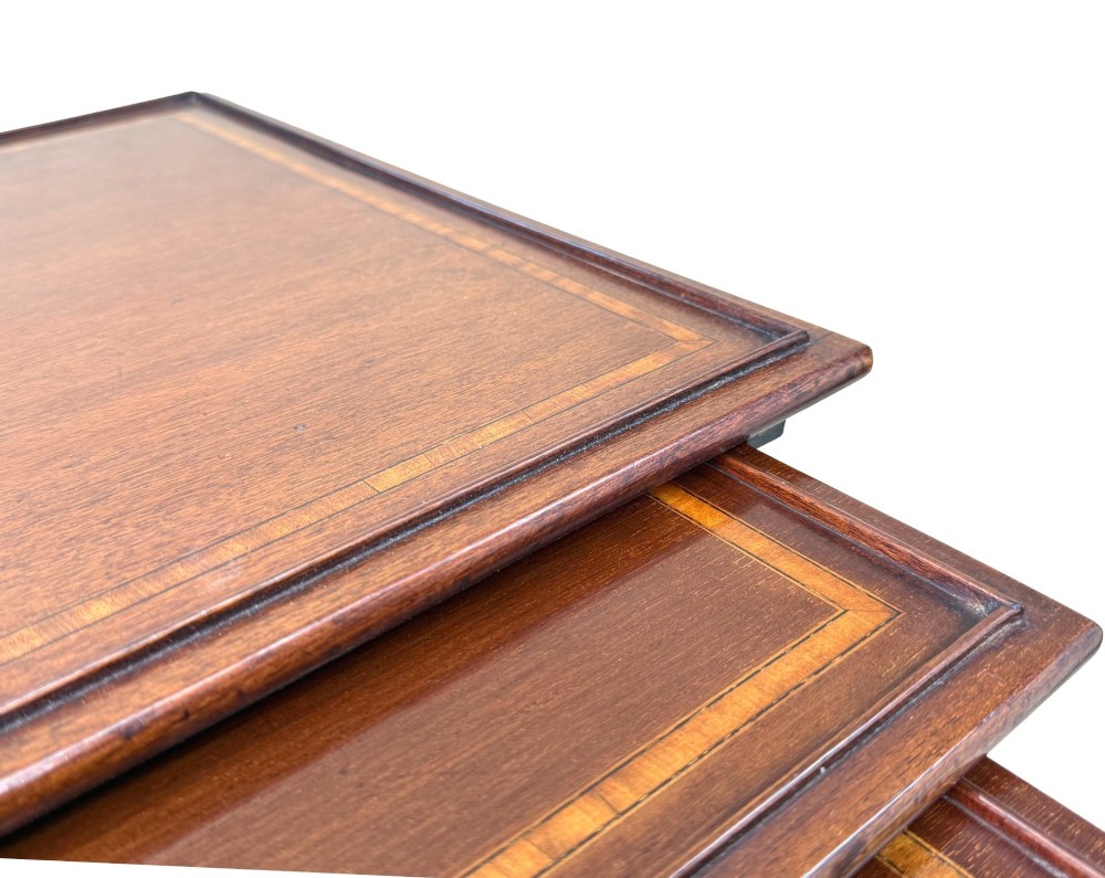 A 19th-century set of four graduated mahogany nesting tables featuring slender turned spindle legs and sledge feet. View IV