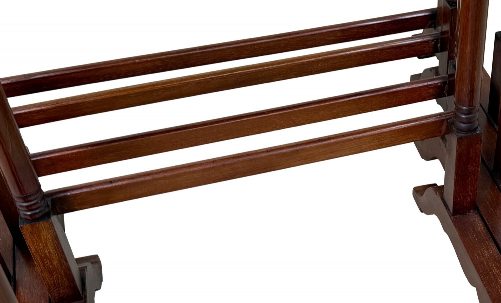 A 19th-century set of four graduated mahogany nesting tables featuring slender turned spindle legs and sledge feet. View V