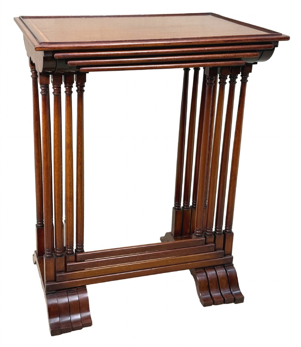 A 19th-century set of four graduated mahogany nesting tables featuring slender turned spindle legs and sledge feet. View VI