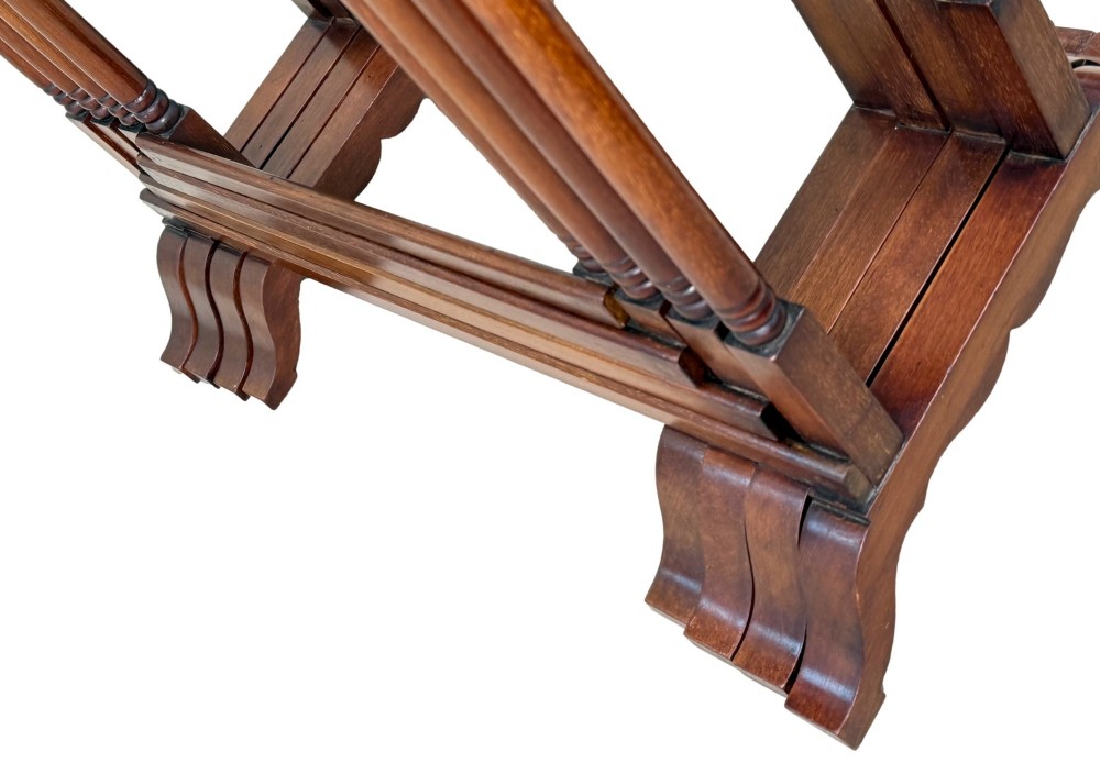 A 19th-century set of four graduated mahogany nesting tables featuring slender turned spindle legs and sledge feet. View VIII