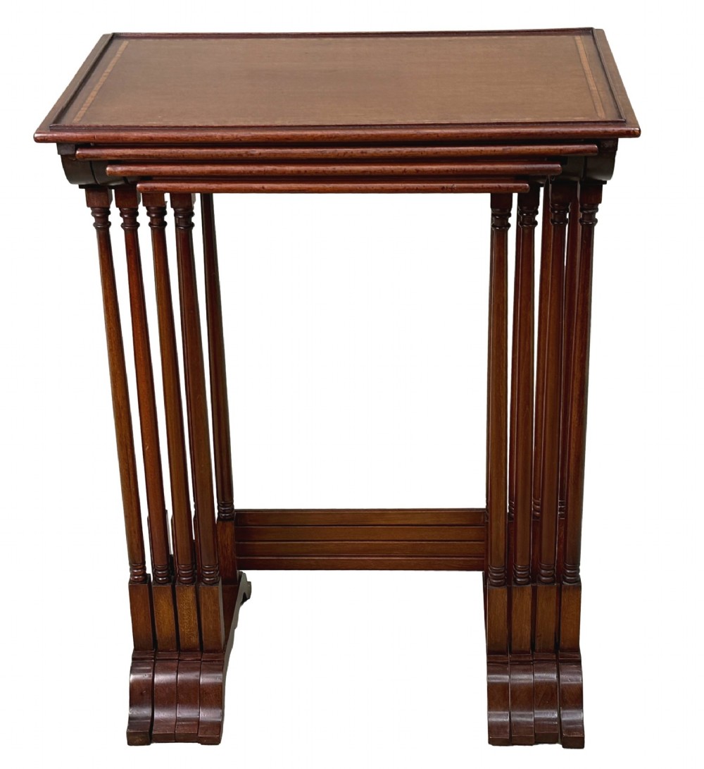 A 19th-century set of four graduated mahogany nesting tables featuring slender turned spindle legs and sledge feet. View XI