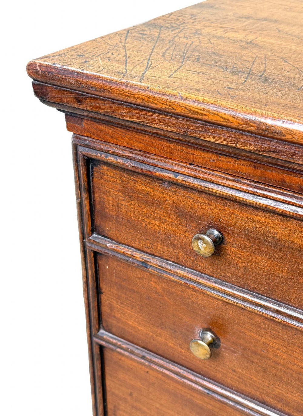 An 18th-century warm brown elm close stool designed as a small Georgian chest of drawers with bracket feet and brass handles. View II