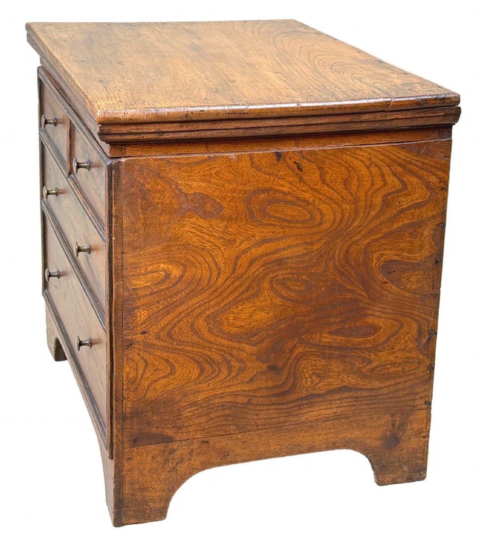 An 18th-century warm brown elm close stool designed as a small Georgian chest of drawers with bracket feet and brass handles. View III