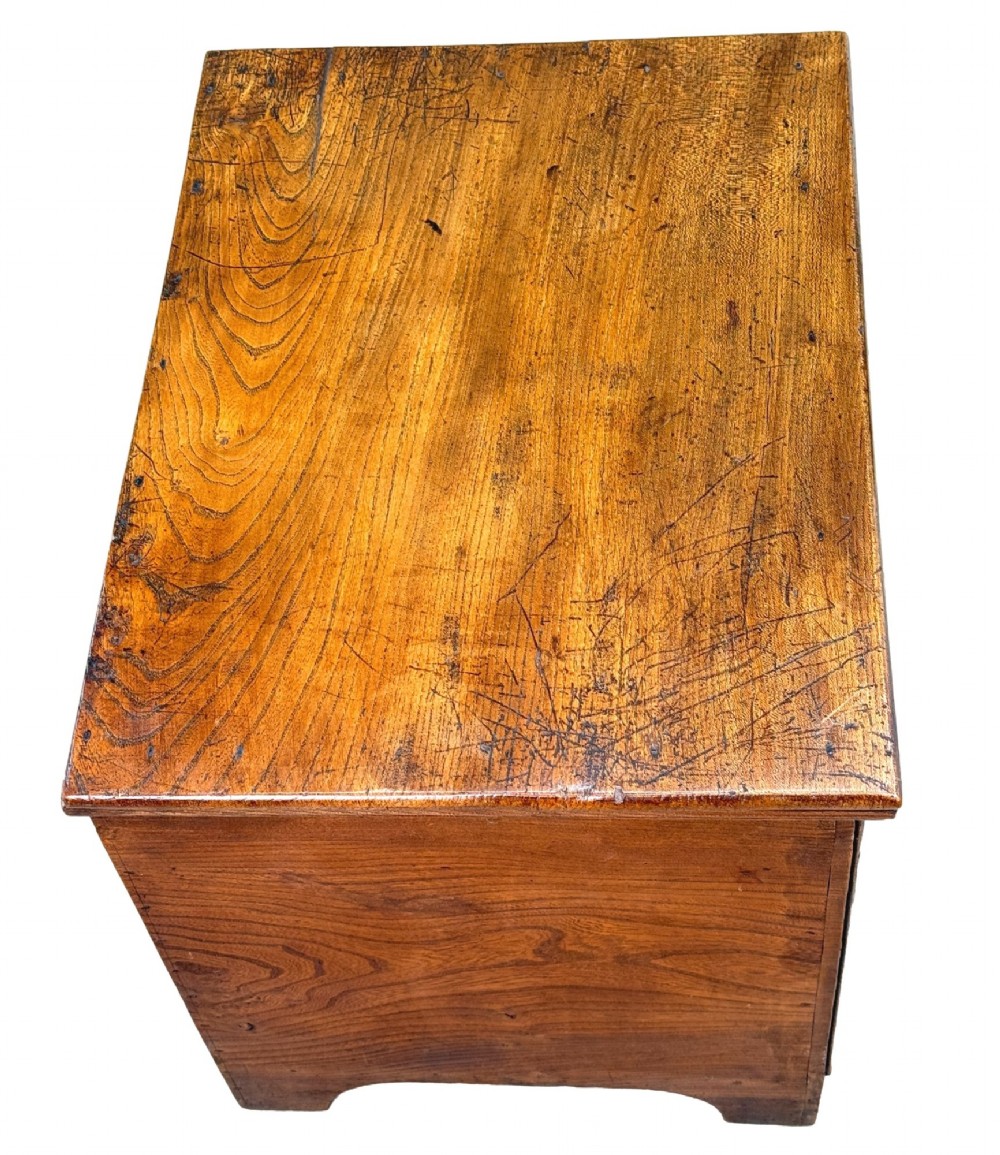 An 18th-century warm brown elm close stool designed as a small Georgian chest of drawers with bracket feet and brass handles. View IV