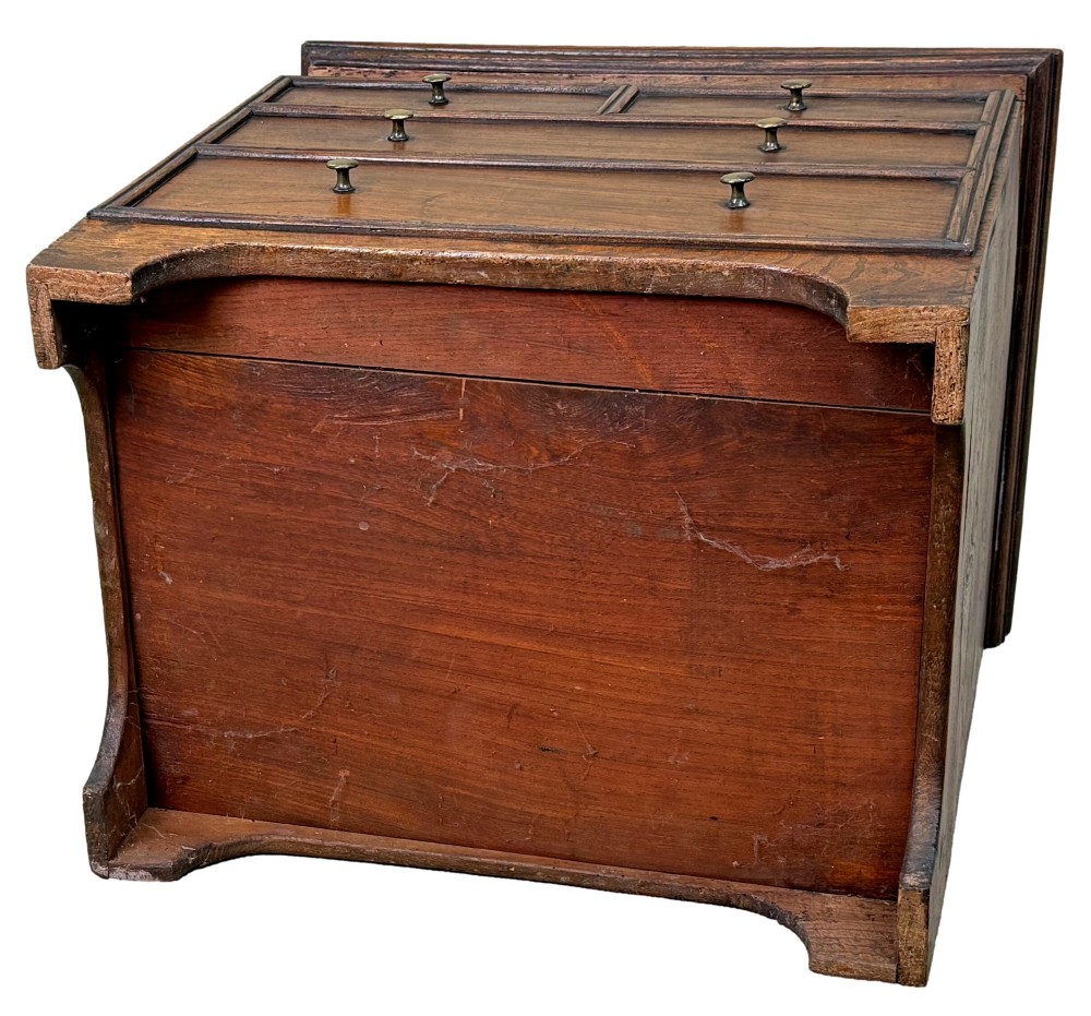 An 18th-century warm brown elm close stool designed as a small Georgian chest of drawers with bracket feet and brass handles. View XI