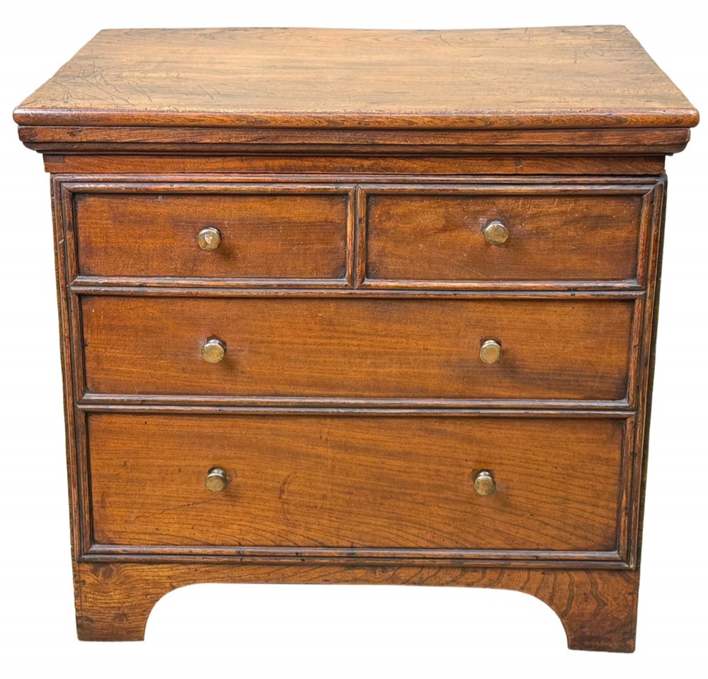 An 18th-century warm brown elm close stool designed as a small Georgian chest of drawers with bracket feet and brass handles. View XII