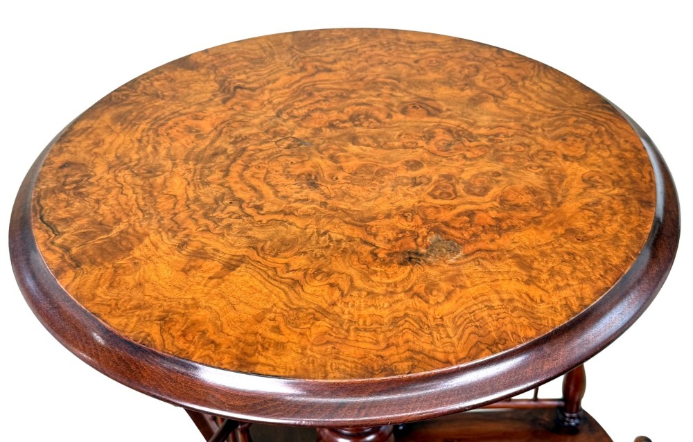 A 19th-century Victorian burr walnut circular occasional table with a central turned column, three-section spindle gallery tier, and a tripod base. View III