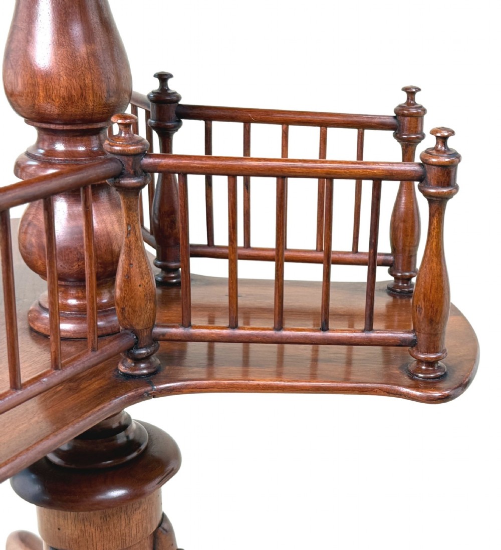 A 19th-century Victorian burr walnut circular occasional table with a central turned column, three-section spindle gallery tier, and a tripod base. View IV