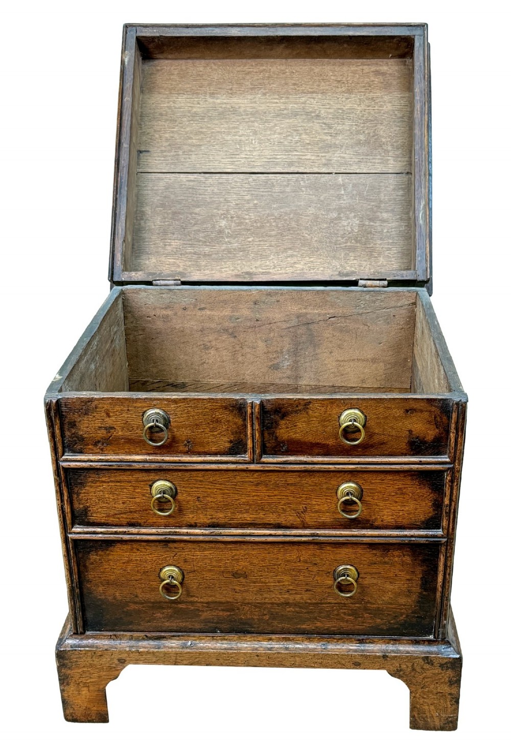 An 18th-century dark oak close stool designed as a small chest with faux drawer fronts, brass ring handles, and bracket feet. View III