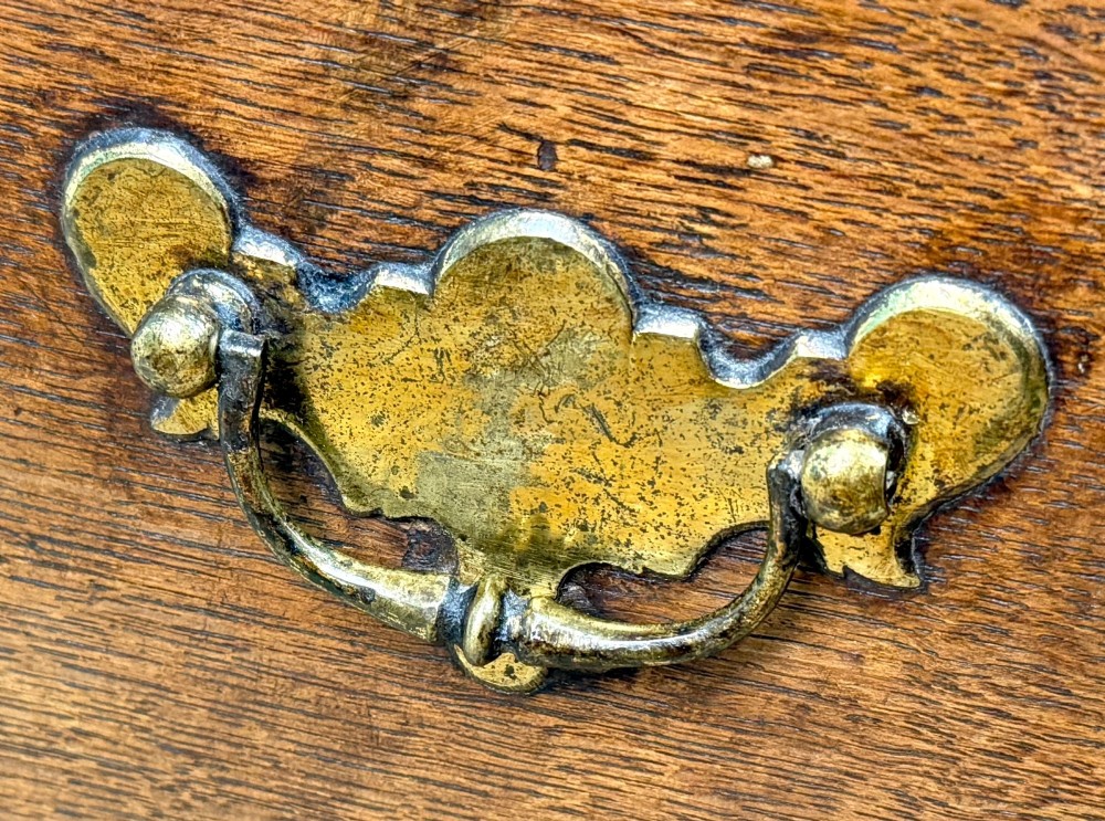 An 18th-century dark oak close stool designed as a small chest with faux drawer fronts, brass ring handles, and bracket feet. View IV