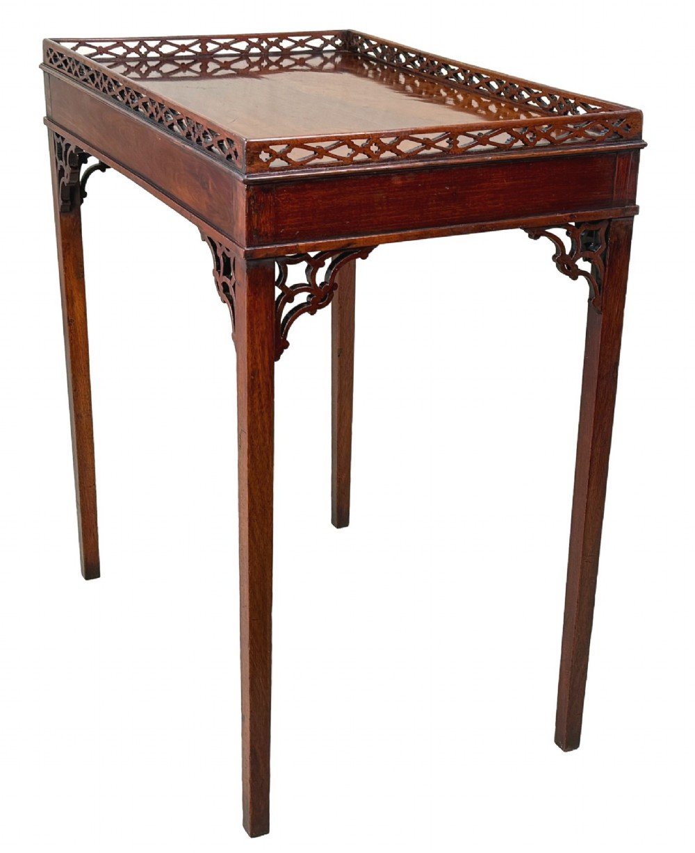 A rectangular dark mahogany silver table featuring a pierced fretwork gallery top, carved corner spandrels, and four straight legs. View III