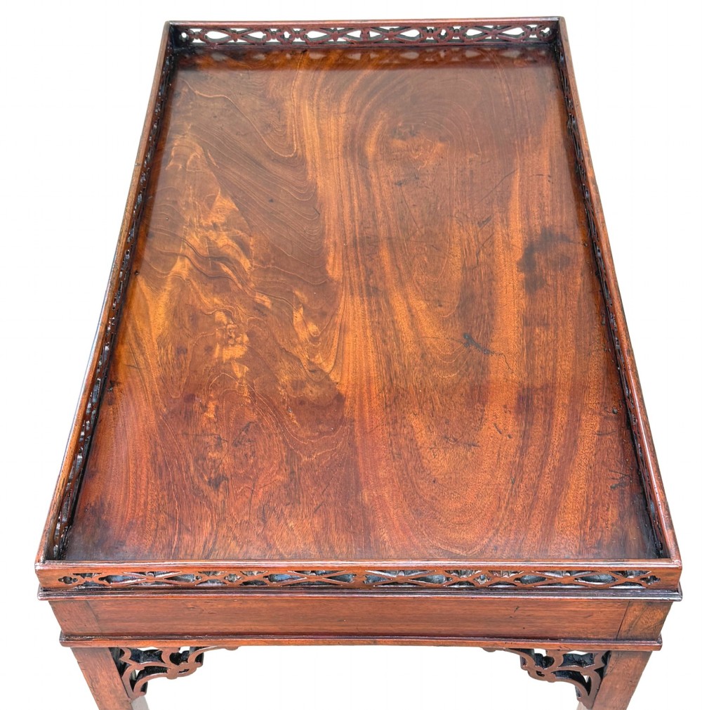 A rectangular dark mahogany silver table featuring a pierced fretwork gallery top, carved corner spandrels, and four straight legs. View V