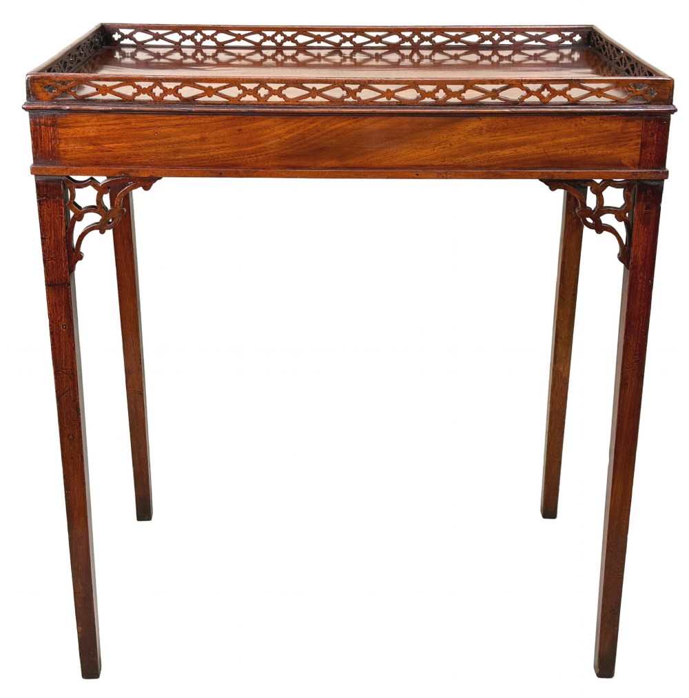 A rectangular dark mahogany silver table featuring a pierced fretwork gallery top, carved corner spandrels, and four straight legs. View VI
