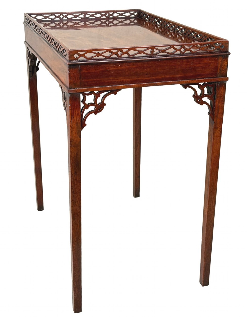 A rectangular dark mahogany silver table featuring a pierced fretwork gallery top, carved corner spandrels, and four straight legs. View VII