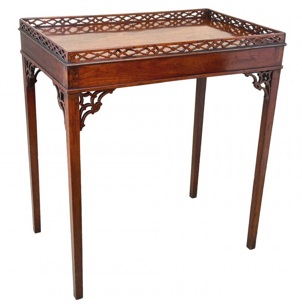 A rectangular dark mahogany silver table featuring a pierced fretwork gallery top, carved corner spandrels, and four straight legs. View IX