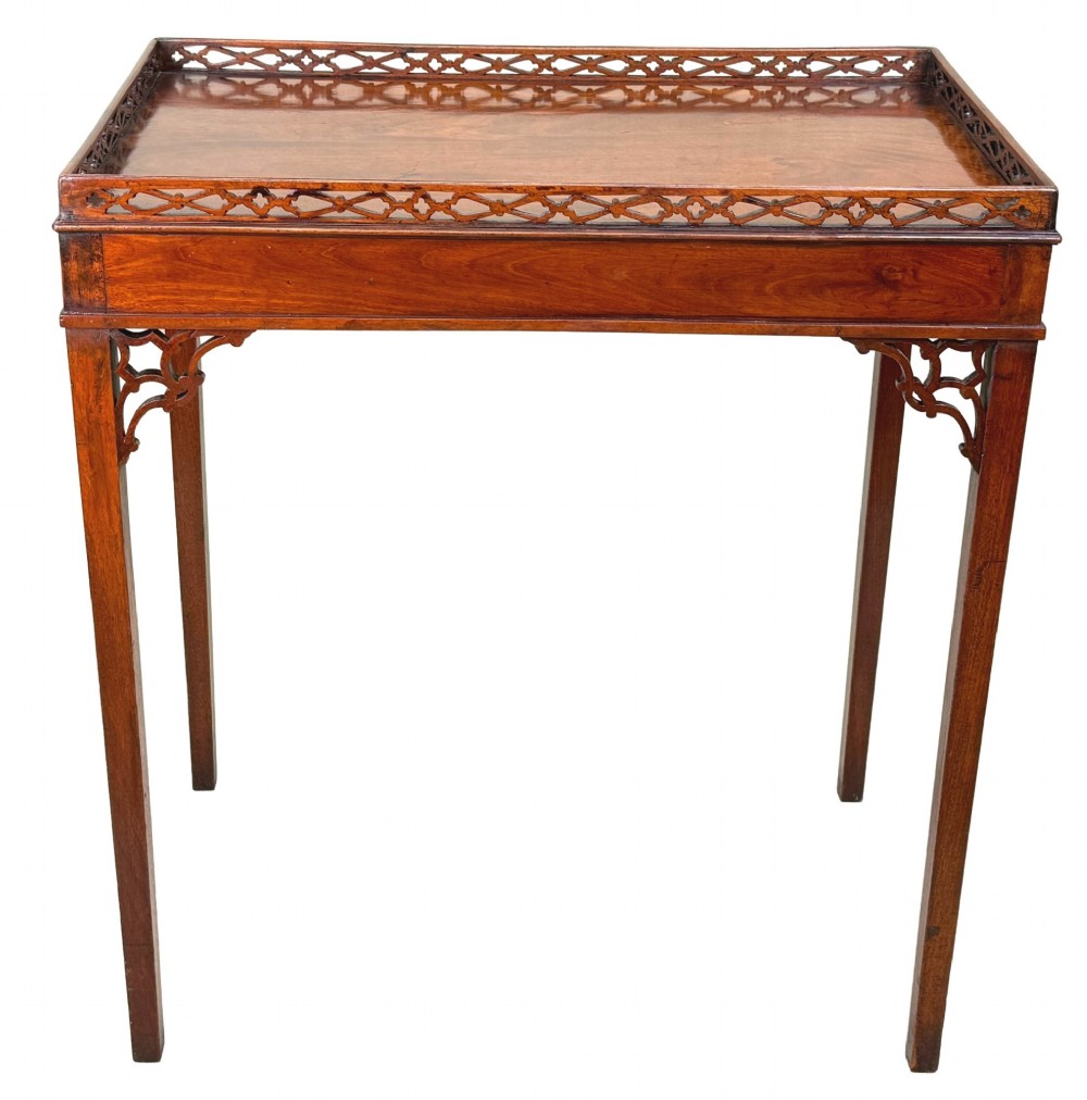 A rectangular dark mahogany silver table featuring a pierced fretwork gallery top, carved corner spandrels, and four straight legs. View XII
