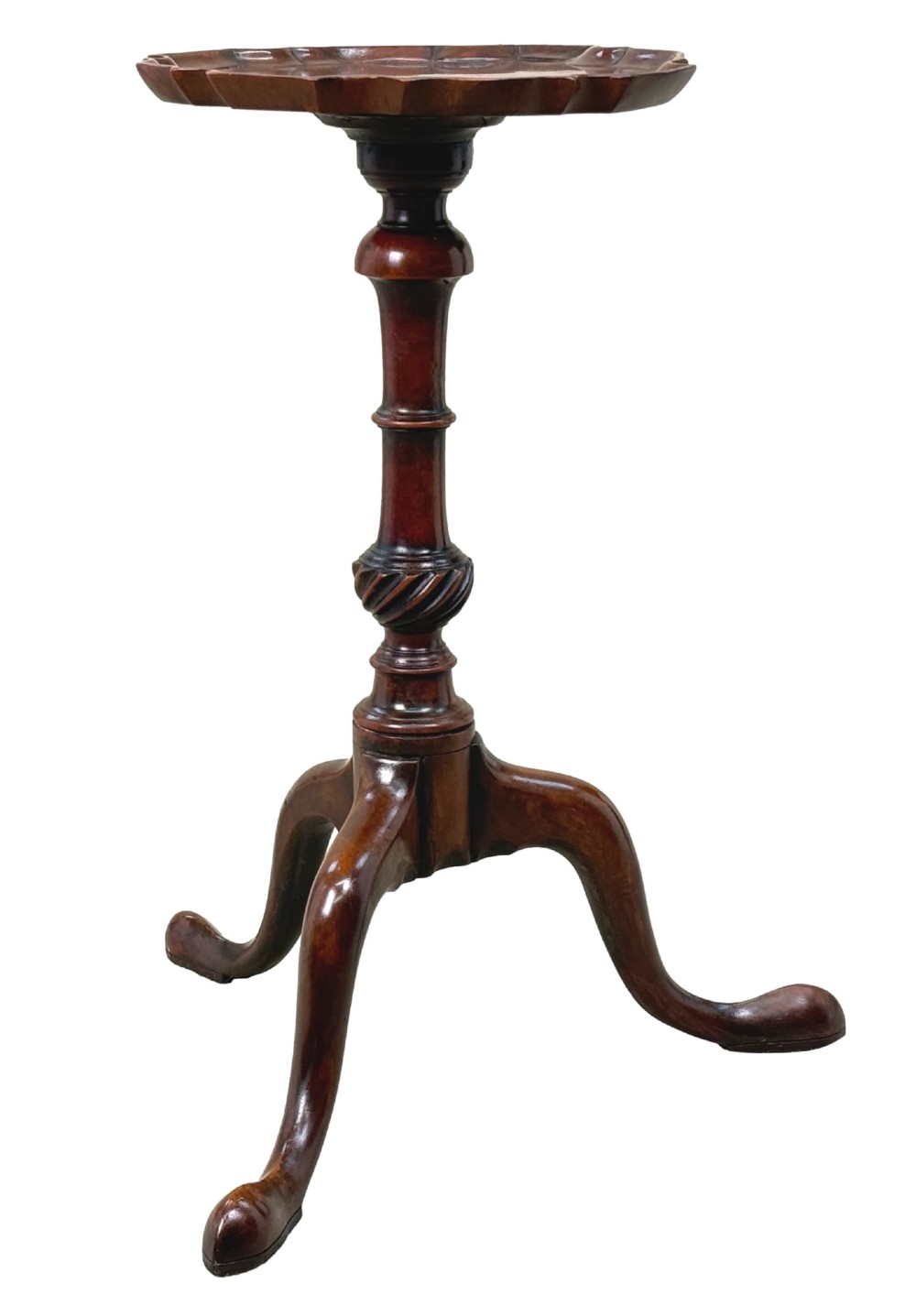 An 18th-century mahogany kettle stand with a raised piecrust top on a turned pedestal column and tripod base.