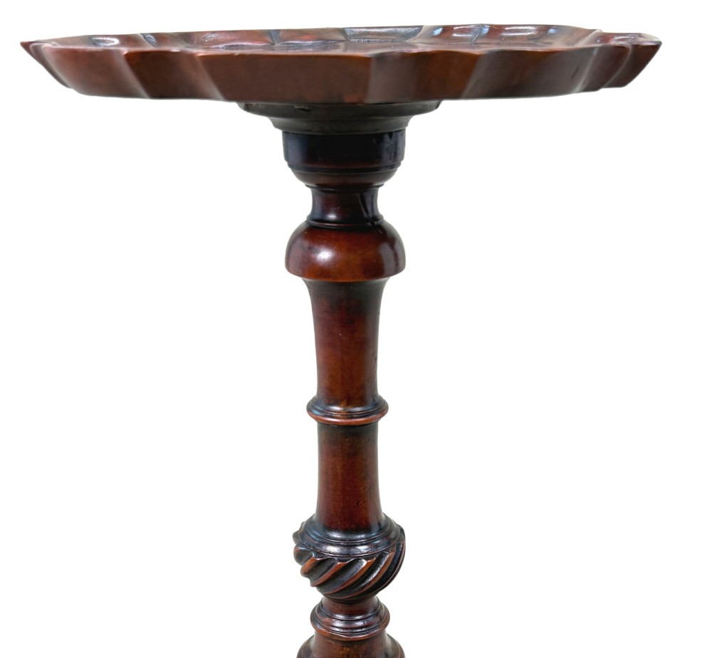 An 18th-century mahogany kettle stand with a raised piecrust top on a turned pedestal column and tripod base. View III