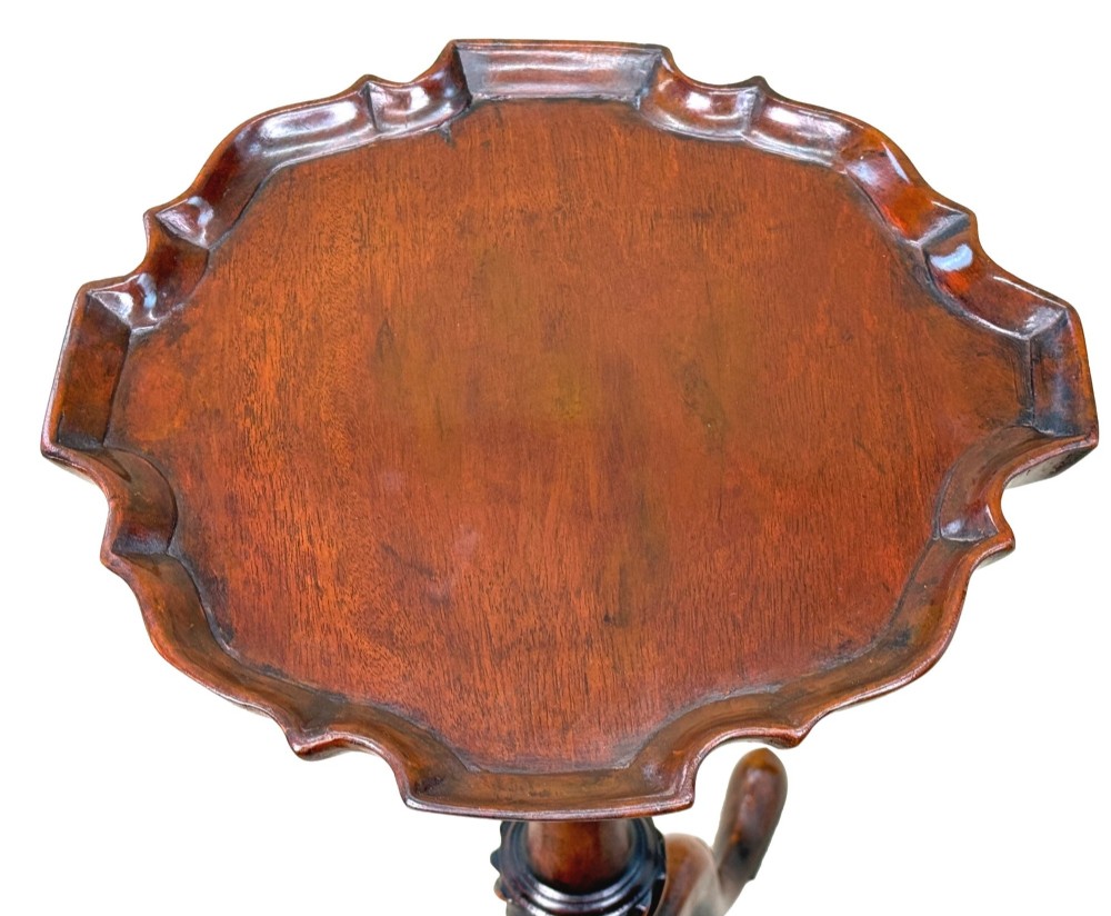 An 18th-century mahogany kettle stand with a raised piecrust top on a turned pedestal column and tripod base. View IV