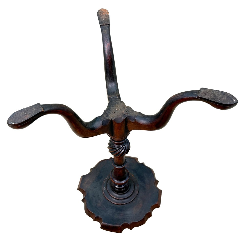 An 18th-century mahogany kettle stand with a raised piecrust top on a turned pedestal column and tripod base. View IX