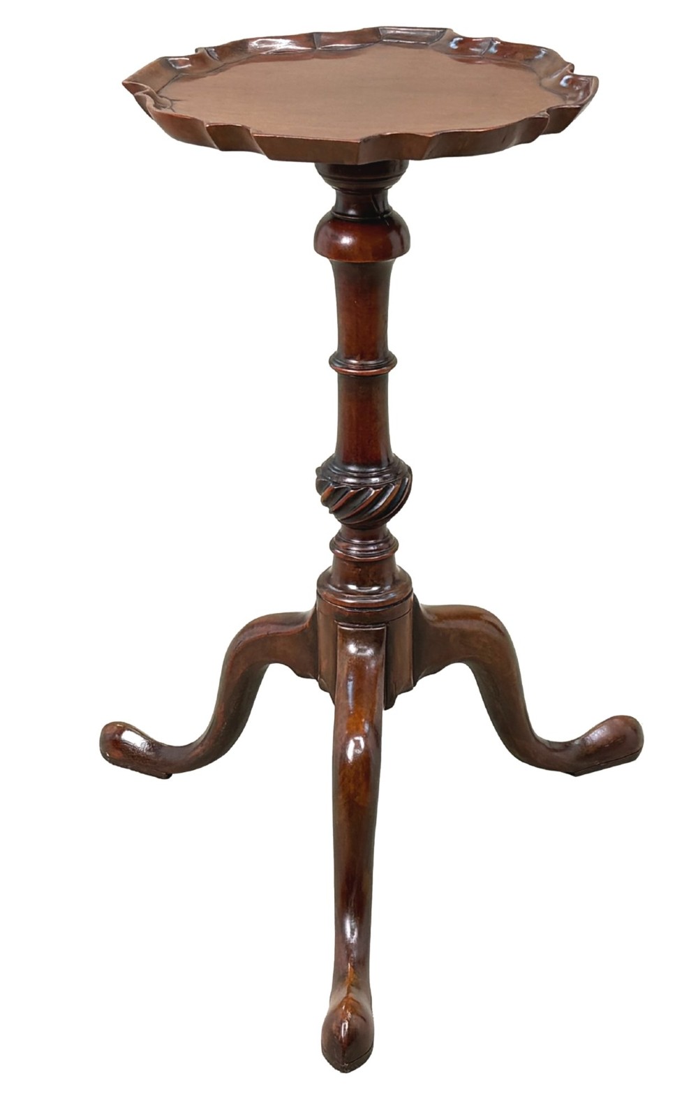An 18th-century mahogany kettle stand with a raised piecrust top on a turned pedestal column and tripod base. View X