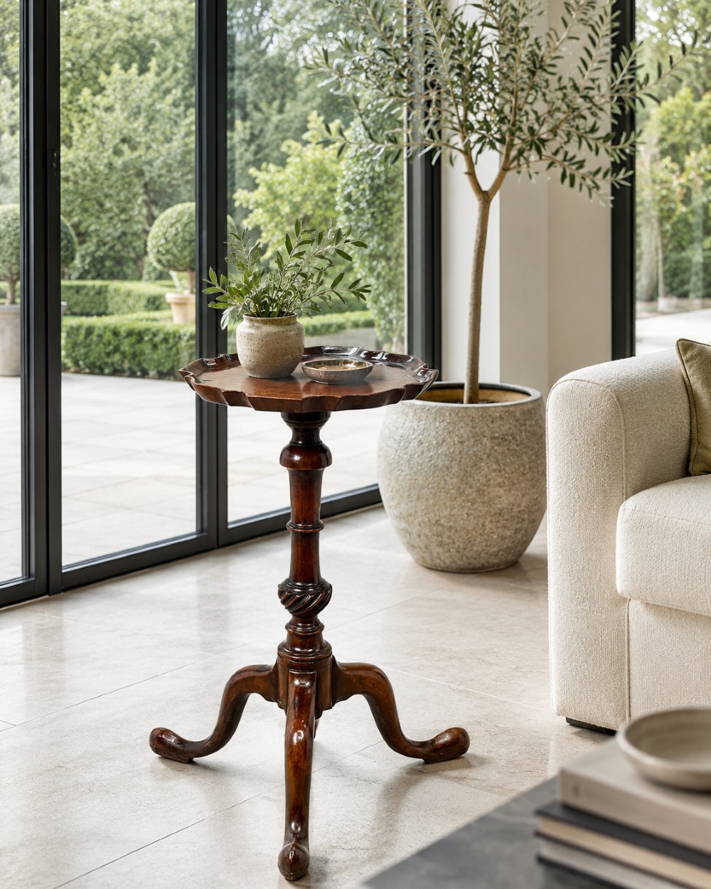 An 18th-century mahogany kettle stand with a raised piecrust top on a turned pedestal column and tripod base. View XI
